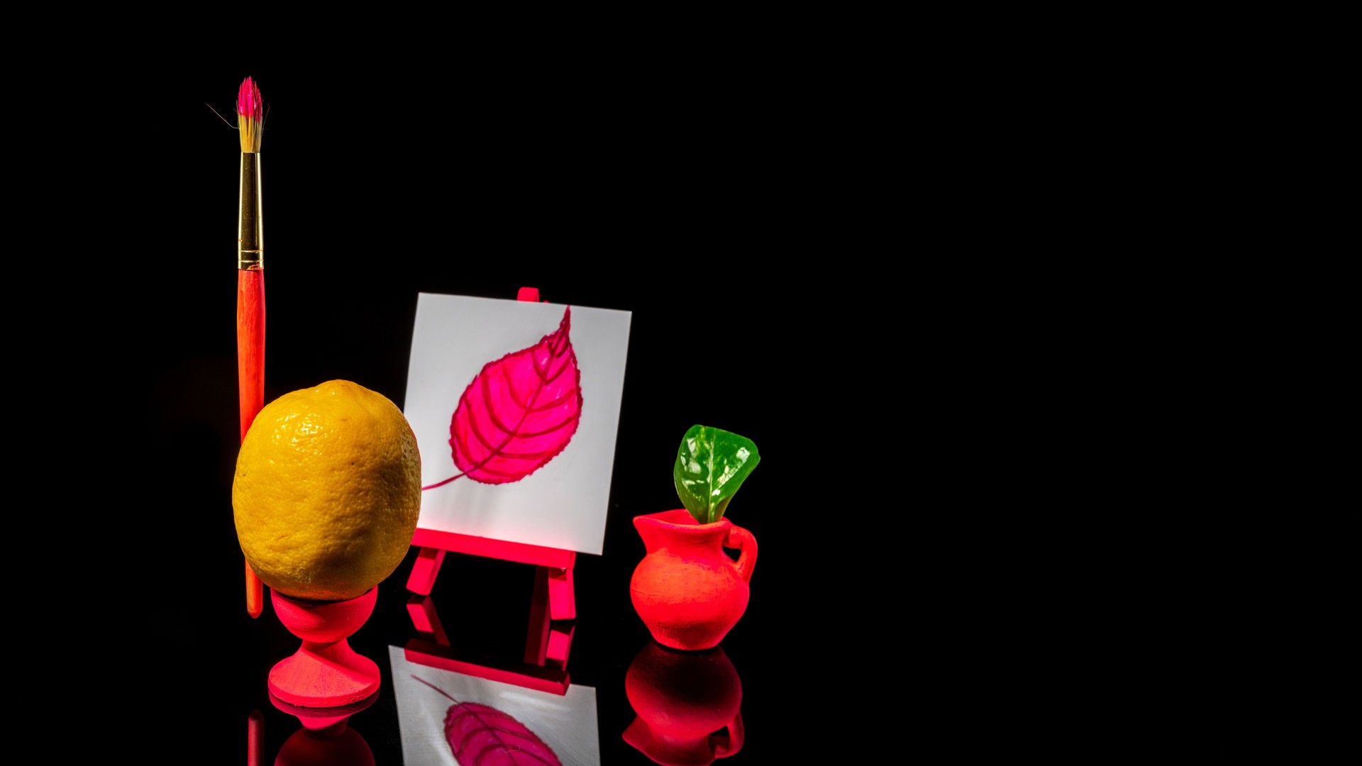 Composition with lemon at the easel on a black background